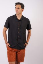Home Model in casual men's fashion with a black shirt and brown shorts on white background.
